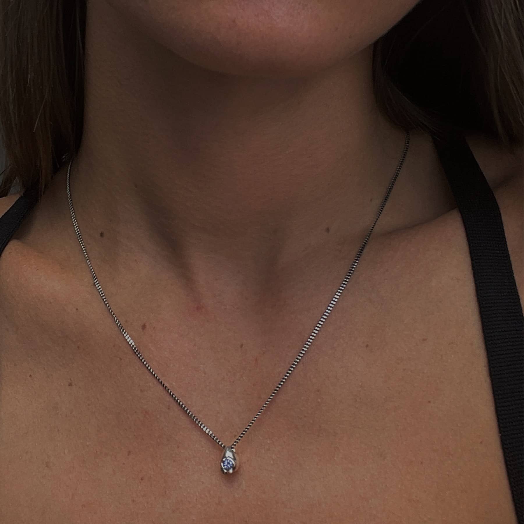 stilla pendant necklace in silver with lilac tanzanite, worn on neck, INNAN Jewellery Berlin