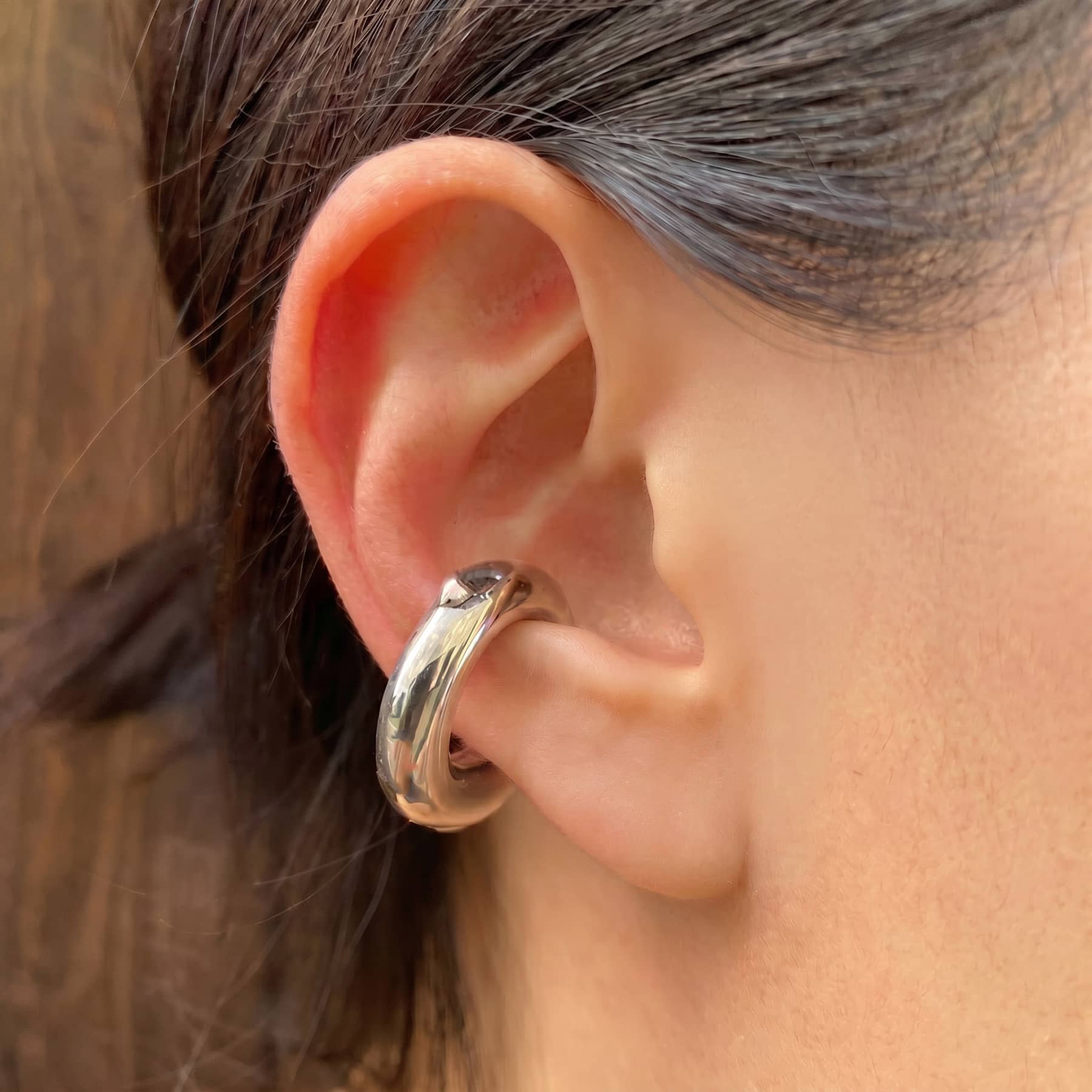 silver alda ear cuff, worn on ear in close-up, INNAN Jewellery Berlin