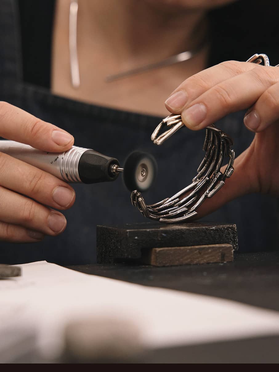 polishing a bracelet by hand at Innan Jewellery Atelier in Berlin