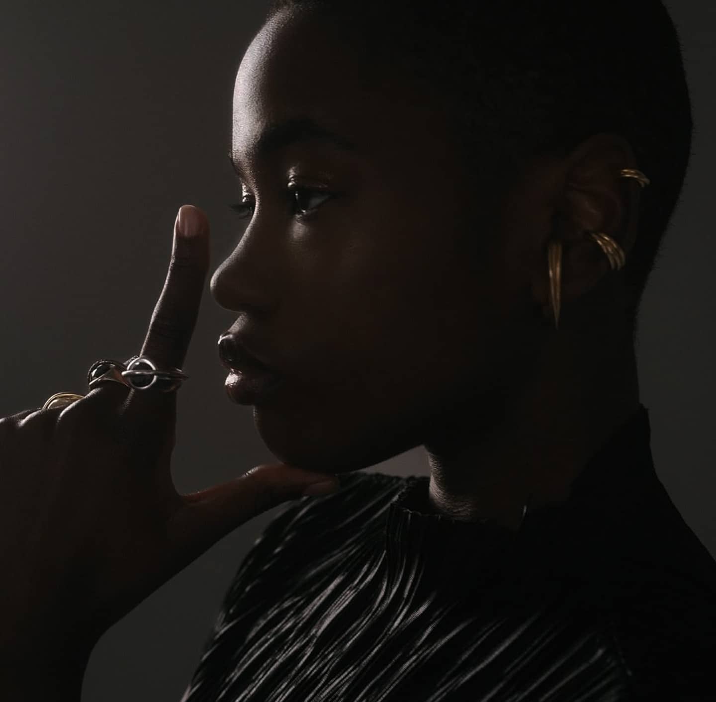 Model wearing rings and earrings by Innan Jewellery