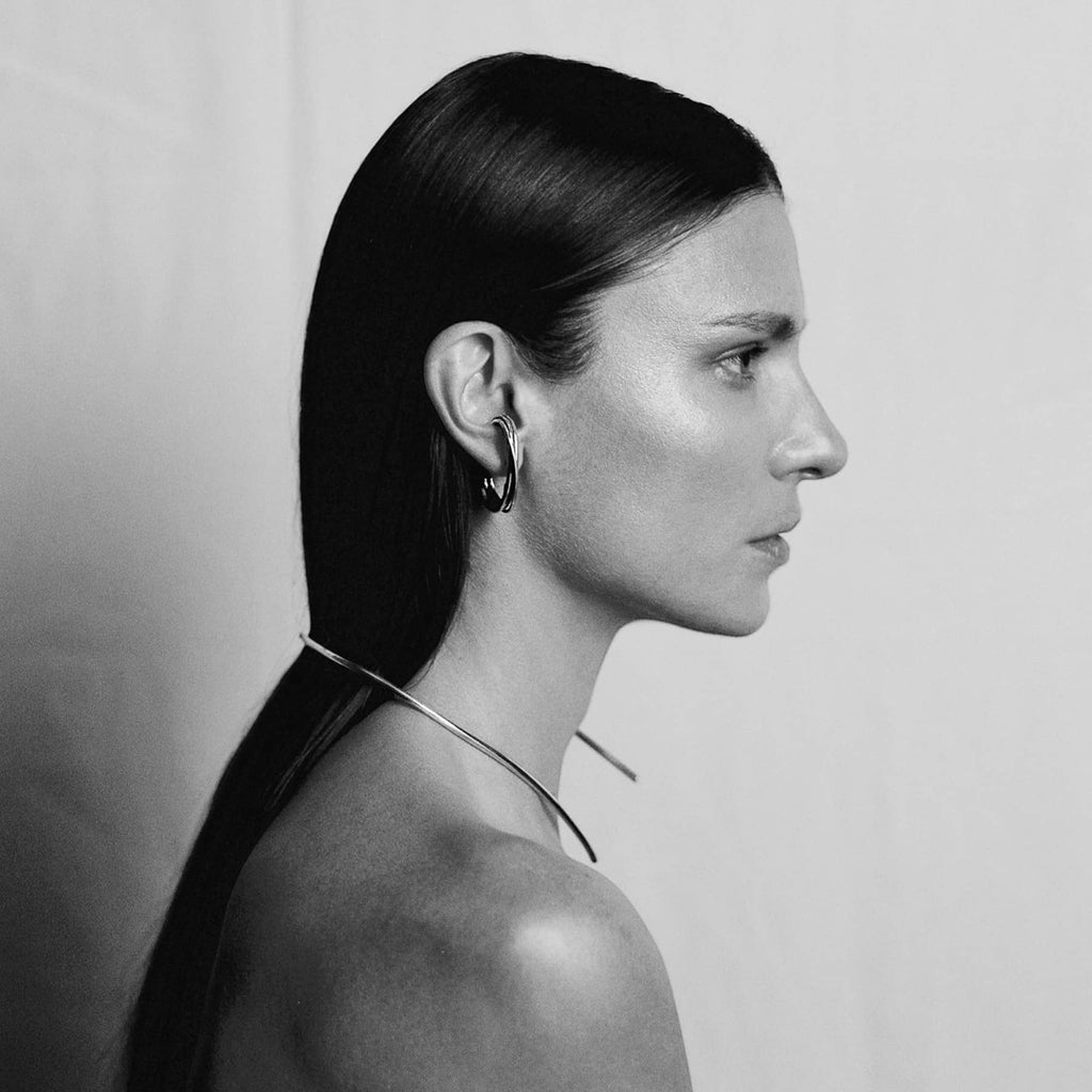 linn earrings is silver, worn on ear, INNAN Jewellery Berlin
