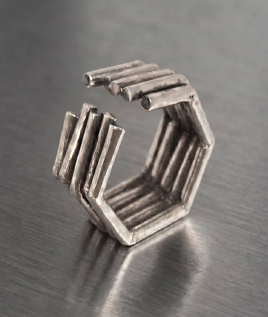 A closeup of a Chaotic Hexagon ring in silver with black diamonds representing the Mens edit collection, INNAN Jewellery Berlin