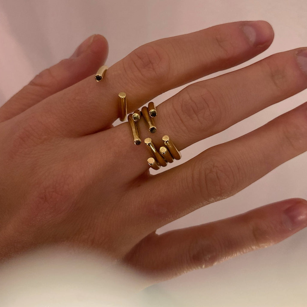 chaotic curve ring in yellow gold with black diamond, product image stacked with chaotic ring with 4 curves from yellow gold, INNAN Jewellery Berlin