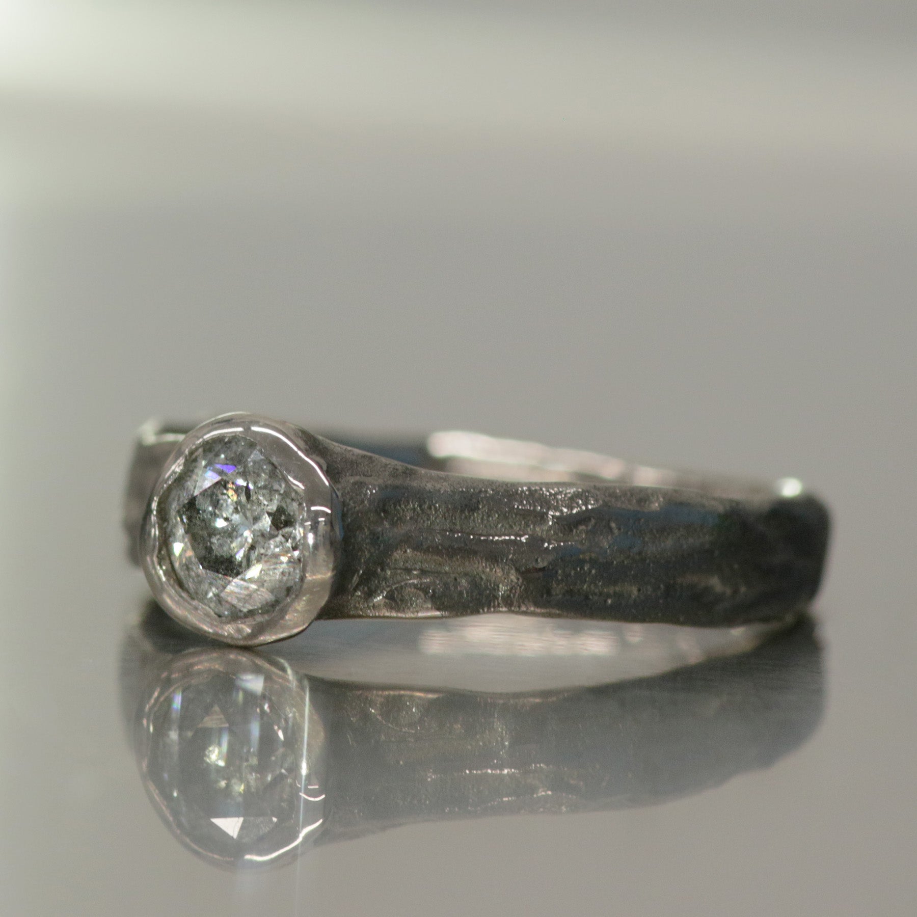 Side view of Verve engagement ring in 18 ct white gold with a 0.52 ct salt and pepper diamond by Innan Jewellery