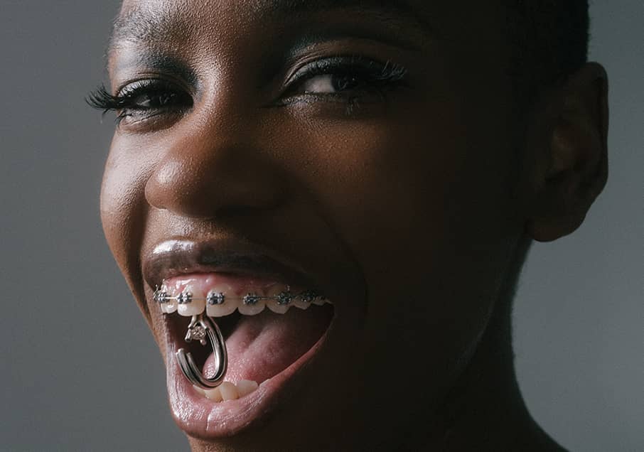 A closeup of a model holding Vortex ring in silver with champagne diamond in her mouth, representing the Vortex collection, INNAN Jewellery Berlin 